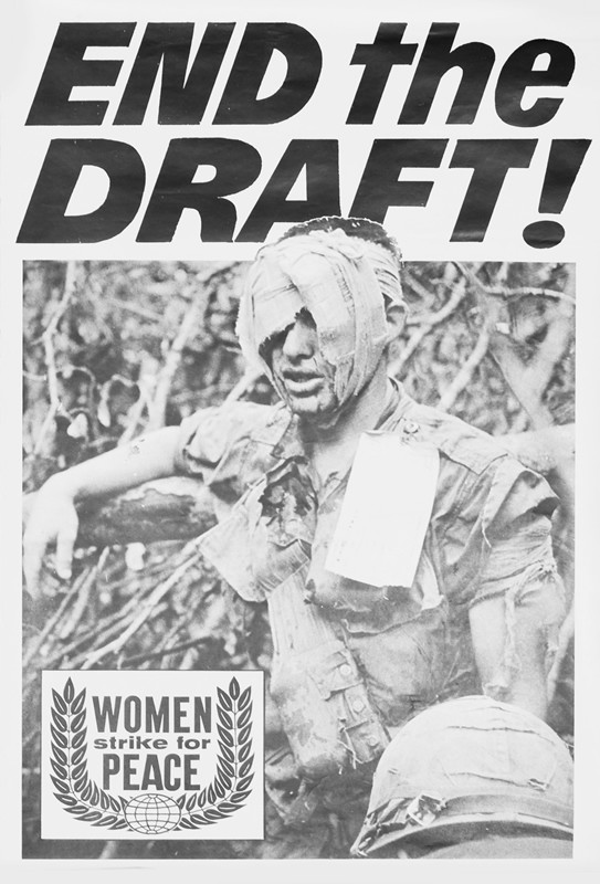 Wounded soldier stands with heavily bandaged head, identifying tag pinned to shirt; black, white