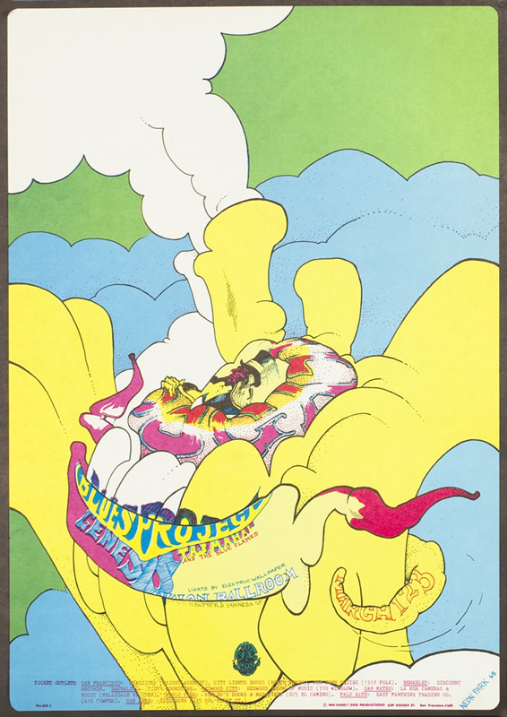 Man inside giant flower form; blue, yellow, green, white