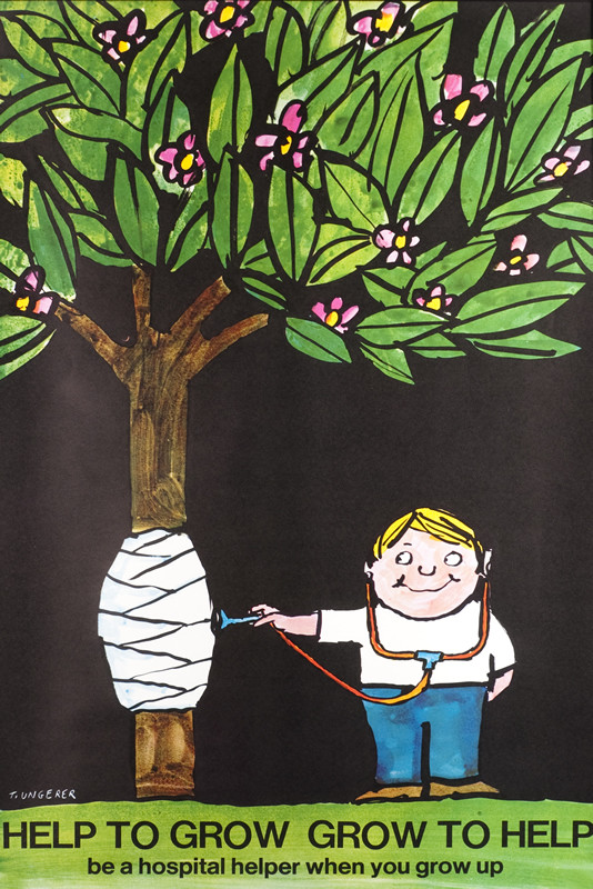 Little boy holds stethoscope up to bandaged tree; black, green, brown, pink