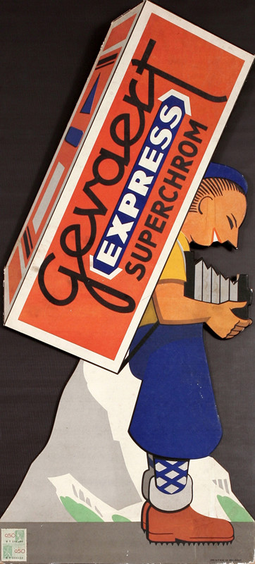 Boy in Alps with camera holds pack of film on his back; blue, green, orange