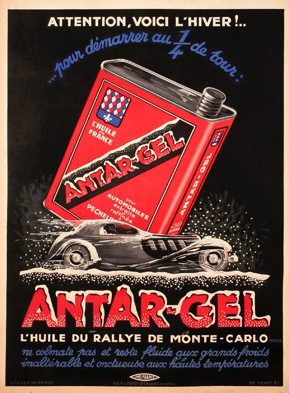 Bugatti Car races in snow beneath giant can of oil; red, blue, black