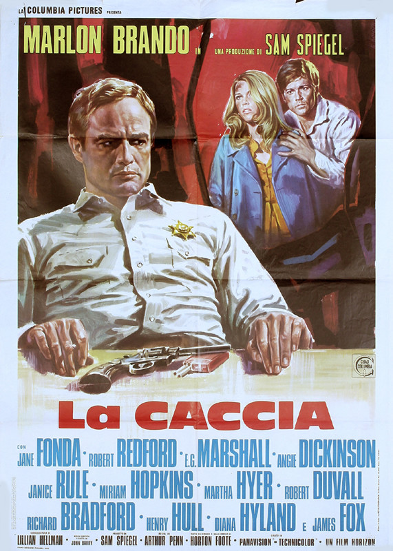 Marlon Brando as sherrif, couple in background; blue, red, brown