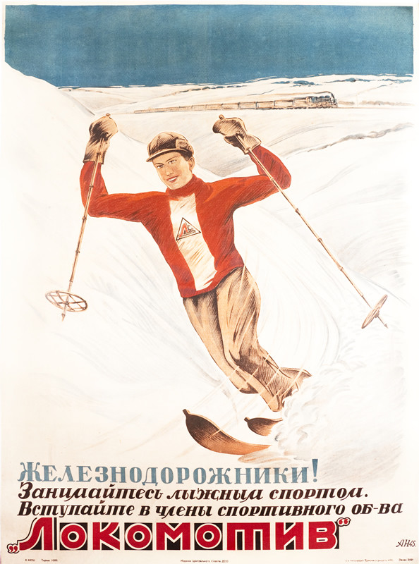 Man speeding down slope with train passing in the distance; blue, red, white