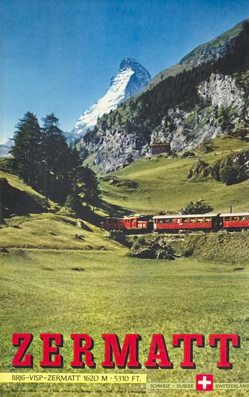 Train cuts through green foothills, snowy Matterhorn behind; blue, red, green