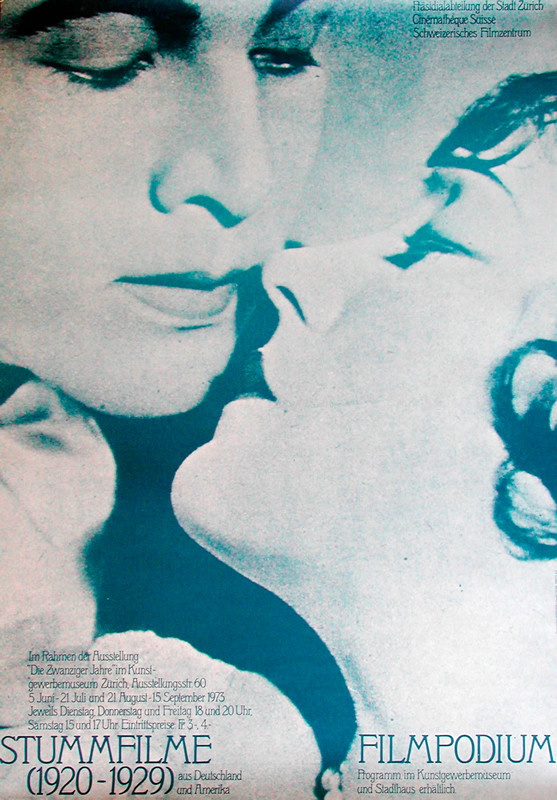 Close-up image of a woman looking up and about to kiss man; Blue