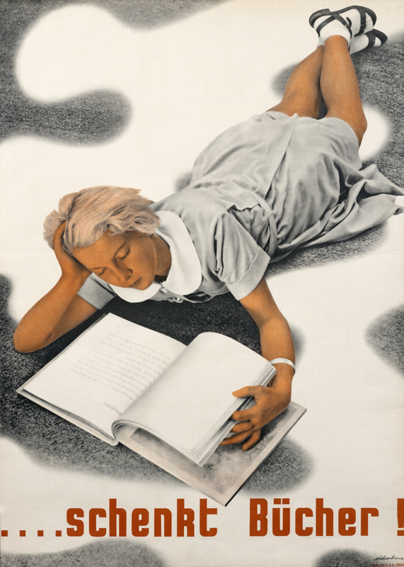 Girl reads book on floor; black, white, red