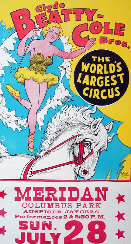 Woman jumps through hoop while standing on back of horse; blue, red, yellow