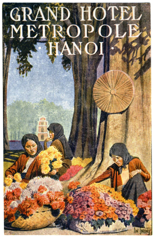 Three women arrange flowers near tree; brown, red, orange