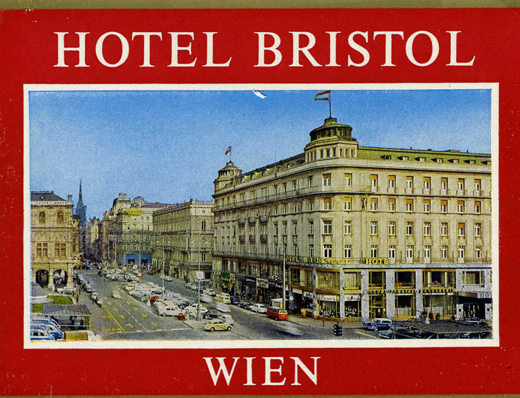 Photograph of hotel and Viennese street; red, blue, white, gold