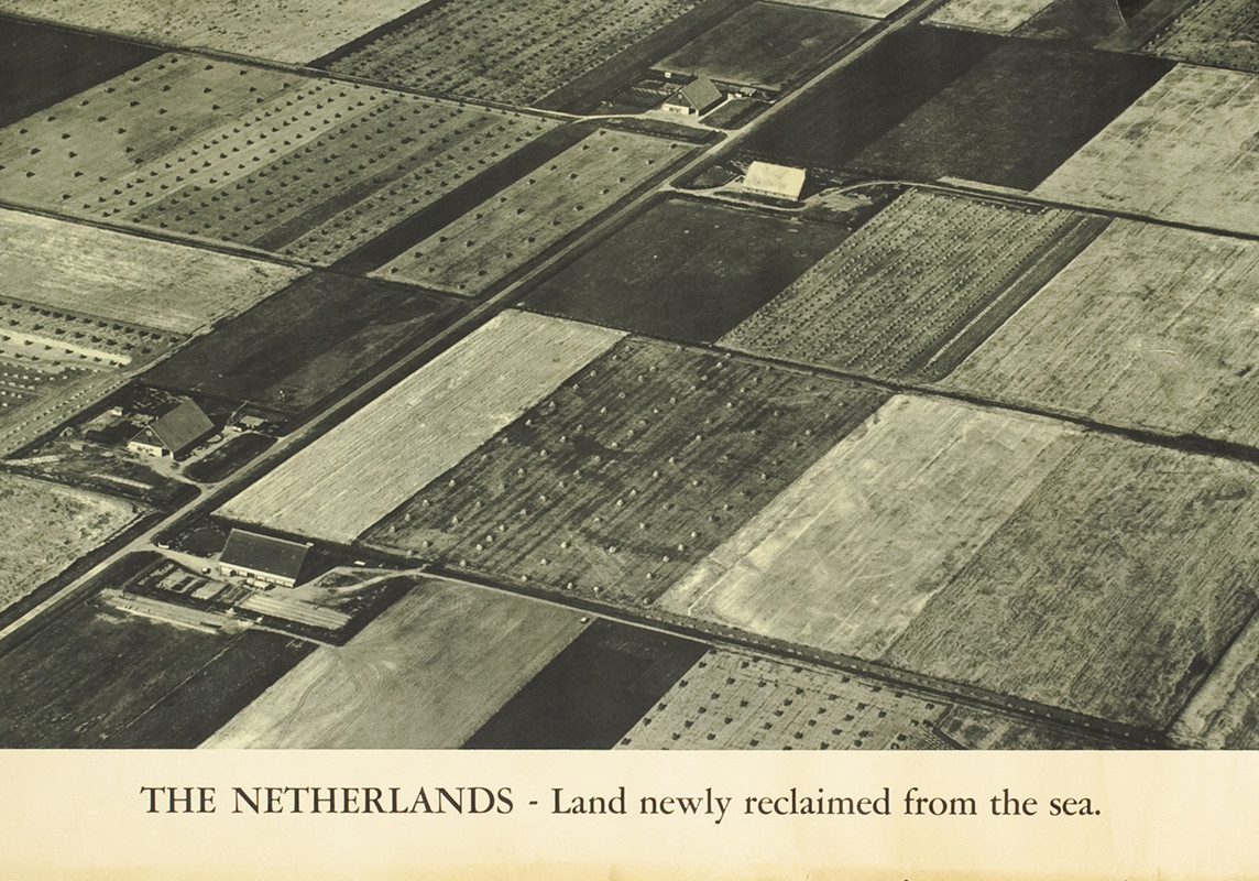 Aerial photograph of farmland, fields, and houses; black, white