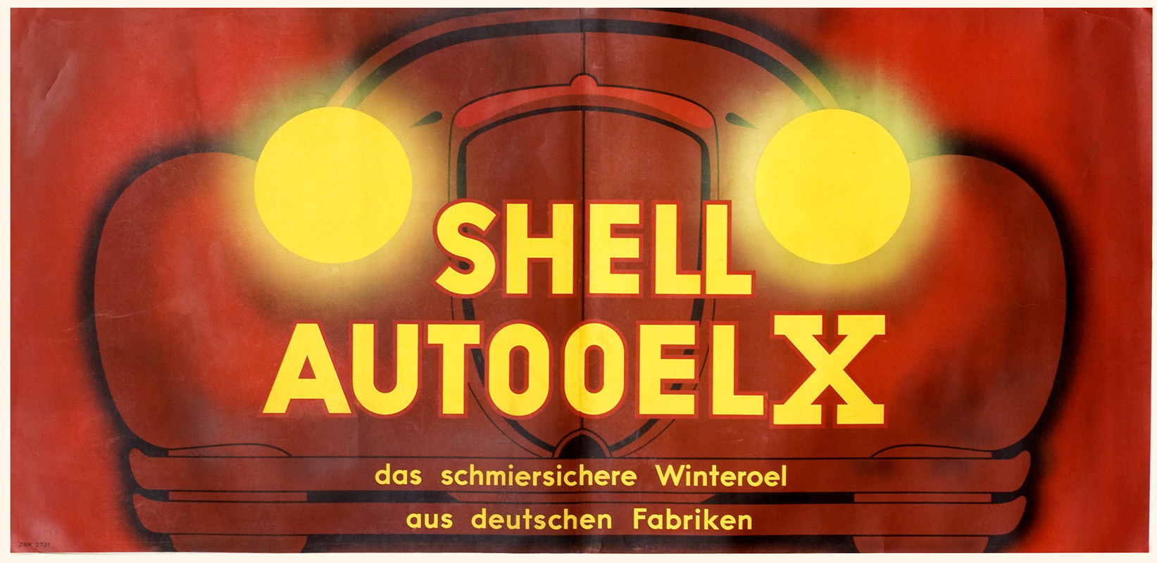 Frontal view of car close-up, headlights beaming; red, yellow, black