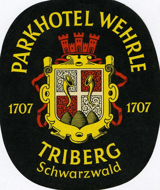 Crest with musical horns topped with a castle and date of 1707; black, red, yellow