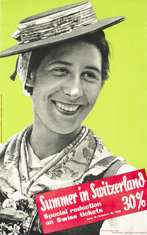 Smiling woman wearing hat and traditional dress; green, red, black, white